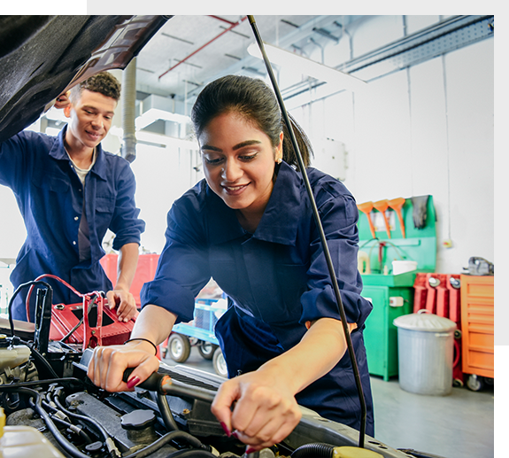 Two Students working on a car