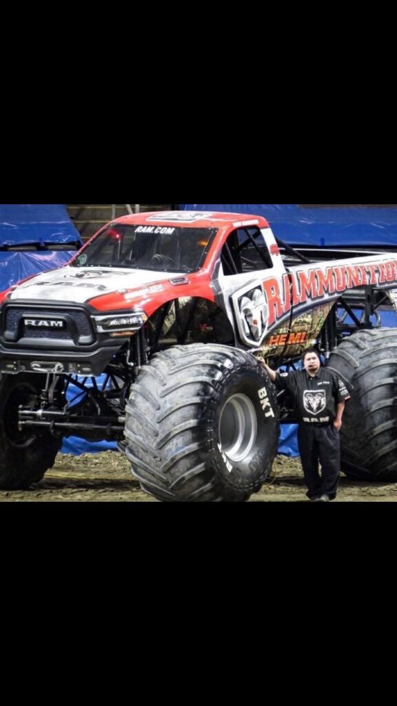 Rosedale Tech Alumnus Daniel Agosh stands next to his monster truck Rammunition