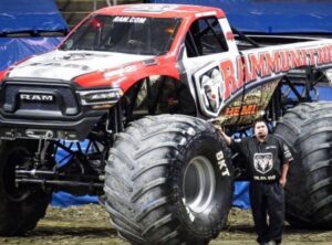 Rosedale Tech Alumnus Daniel Agosh stands next to his monster truck Rammunition