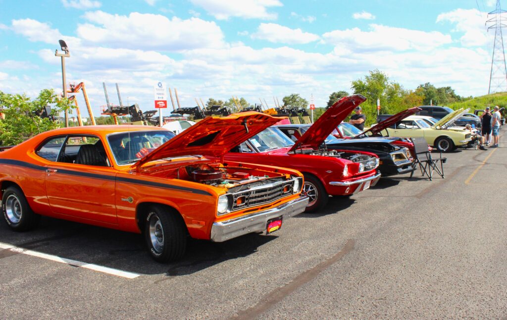 Various vehicles displayed outside at Rosedale Tech's Car Show in 2024