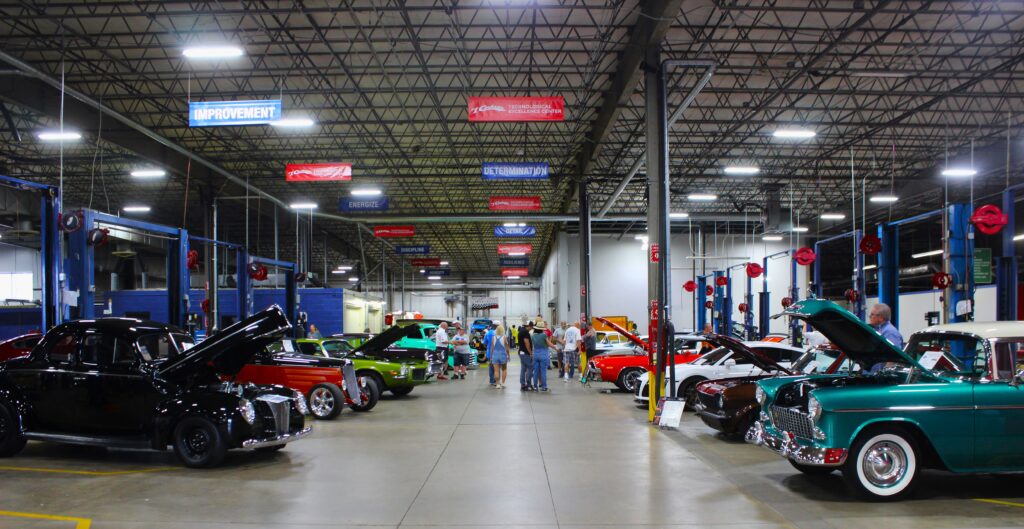 Various vehicles displayed inside the #1 Cochran TechEx Center at Rosedale Tech's Car Show in 2024