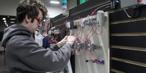 industrial electricity student working on a wiring panel.