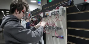 industrial electricity student working on a wiring panel.